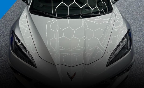 The front end of a silver Corvette.